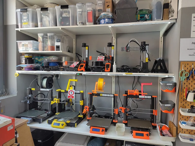 Rows of desktop 3D printers in a hackerspace